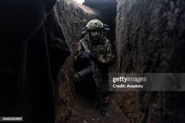 Ukrainian soldier crouching in a trench in his infantry position as the Russia-Ukraine war continues in the direction of Kupiansk, Kharkiv Oblast,...
