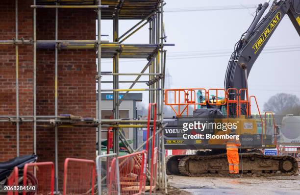 An employee cleans a digger at a Persimmon Plc residential property construction site in Braintree, UK, on Monday, March 11, 2024. Persimmon are due...