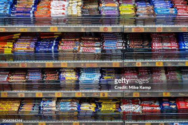 Sweets, confectionary and various well known branded chocolate bars for sale at a small shop on 6th March 2024 in London, United Kingdom.