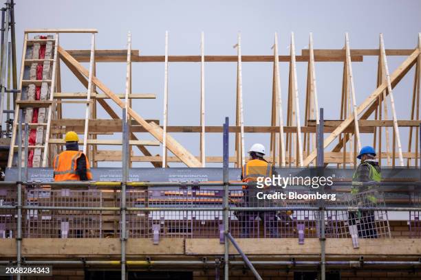 Employees construct the roof of a home at a Persimmon Plc residential property construction site in Braintree, UK, on Monday, March 11, 2024....