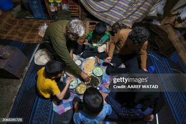 Family breaks their fast on the first day of the Muslim holy fasting month of Ramadan, at the Batinta camp for the internally displaced in the north...