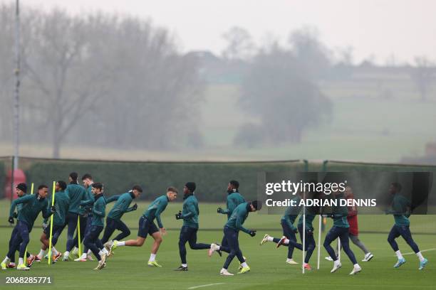 Arsenal's team players take part in a training session on the eve of the UEFA Champions League round of 16 second leg football match against FC...