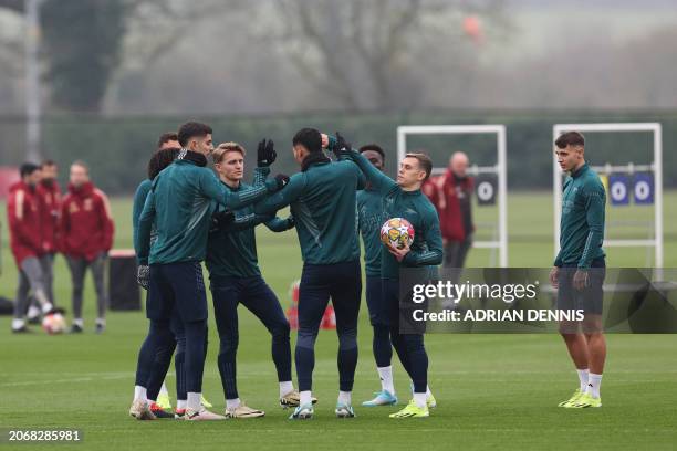 Arsenal's German midfielder Kai Havertz and Arsenal's Belgian midfielder Leandro Trossard flick Arsenal's French defender William Saliba's ear as...