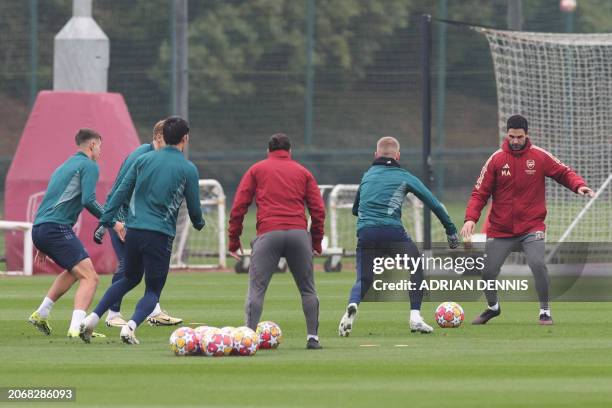 Arsenal's Spanish manager Mikel Arteta leads a training session on the eve of the UEFA Champions League round of 16 second leg football match against...