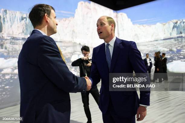 Britain's William, Prince of Wales speaks with an attendee, at an event celebrating The Earthshot Prize Launchpad, in London, on March 11, 2024 ....