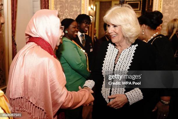 Queen Camilla talks to guests during a Commonwealth Day Reception at Marlborough House on March 11, 2024 in London, England.