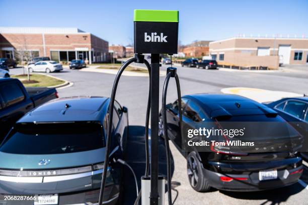 Electric vehicles charge outside of Blink Charging's new flagship manufacturing facility in Bowie, Md., on Monday March 11, 2024.