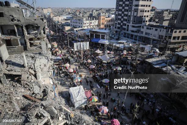 Palestinians are shopping in Nuseirat Market in the central Gaza Strip on March 11 during the first day of Ramadan, amid ongoing battles between...