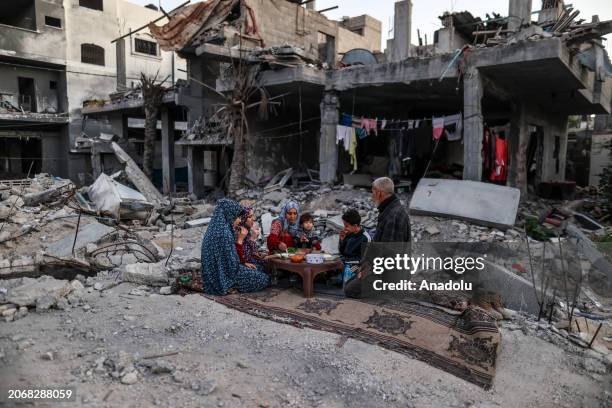 Palestinian Khaled al-Naji and his family have first fast-breaking dinner among the rubbles of their destroyed house, due to Israeli attacks, on the...