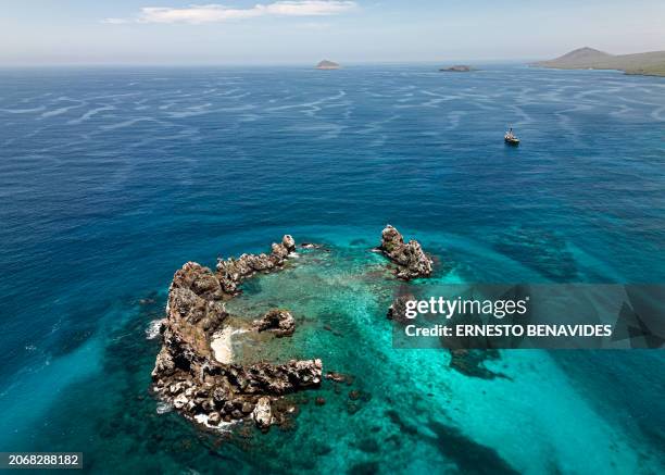 Aerial view of the ship Arctic Sunrise sailing during a scientific expedition by Greenpeace near La Corona del Diablo in the Galapagos archipelago,...
