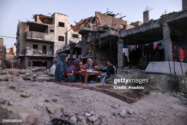 Palestinian Khaled al-Naji and his family have first fast-breaking dinner among the rubbles of their destroyed house, due to Israeli attacks, on the...