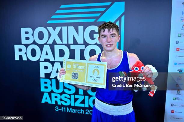 Lombardy , Italy - 11 March 2024; Jude Gallagher of Ireland, celebrates while holding a ticket and a mascot after winning their Men's 57kg...
