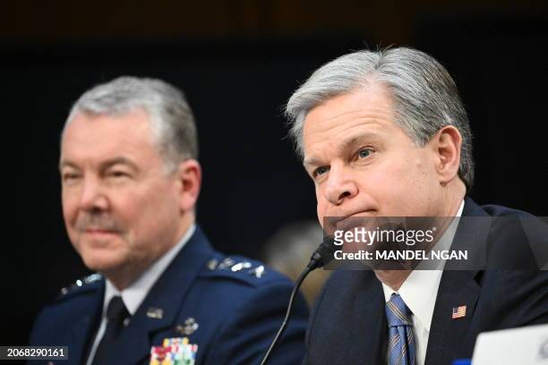 Director of the Defense Intelligence Agency Lieutenant General Jeffrey Kruse and FBI Director Christopher Wray testify during a Senate Select...