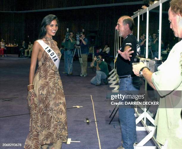 Lara Dutta, Miss India 2000, takes direction from stage manager Ken Stein , during a rehearsal 06 May 2000 in Nicosia for the upcoming Miss Universe...