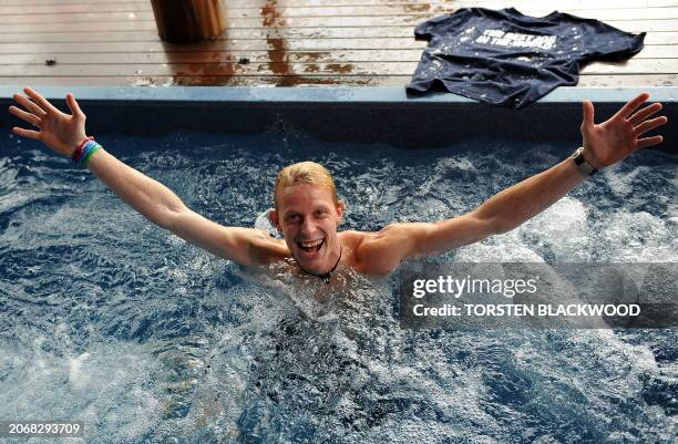 Ben Southall of Britain tries out the jacuzzi spa of his 'Blue Pearl' accommodation a day after winning the 'Best Job In The World' competition on...