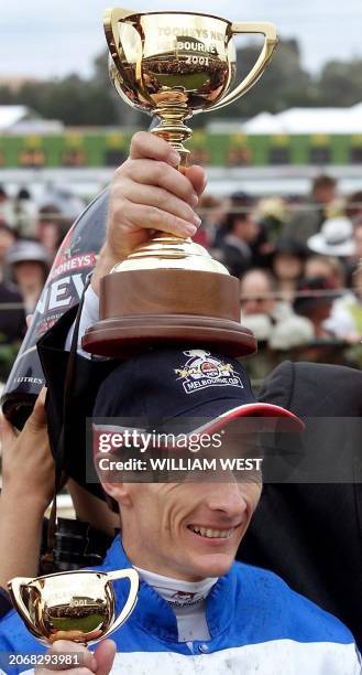 Scott Seamer, jockey of winning New Zealand horse Ethereal has the trophy placed on his head after Ethereal won the 140th running of the Melbourne...