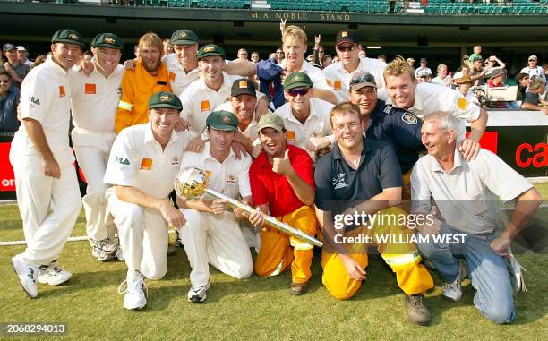 The Australian cricket team displays the ICC World Championship Test Trophy with firefighters to whom they donated their prize winnings of 25,000 US...