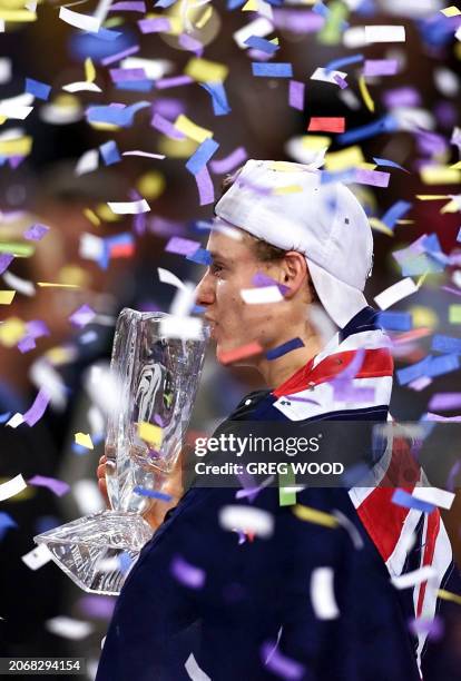 Confetti falls on Australian Lleyton Hewitt as he holds the trophy after defeating Sebastien Grosjean of France in the final of the Tennis Masters...
