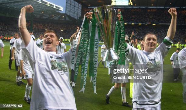 Celtic captain Tom Boyd and Tommy Johnson hold up the cup to the fans at after the Scottish Premier League match between Celtic and Hearts at Celtic...