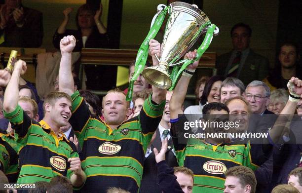 Northampton's captain Pat Lam and the club's former captain Tim Rodber hoist the cup watched Ben Cohen after winning the Heineken Rugby Cup Final at...