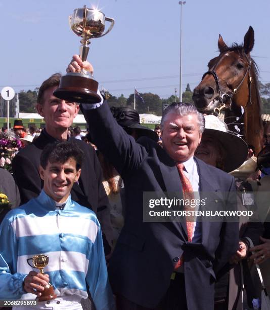 Legendary Australian trainer Bart Cummings celebrates with jockey John Marshall after "Rogan Josh" won the Melbourne Cup 02 November 1999 ahead of...