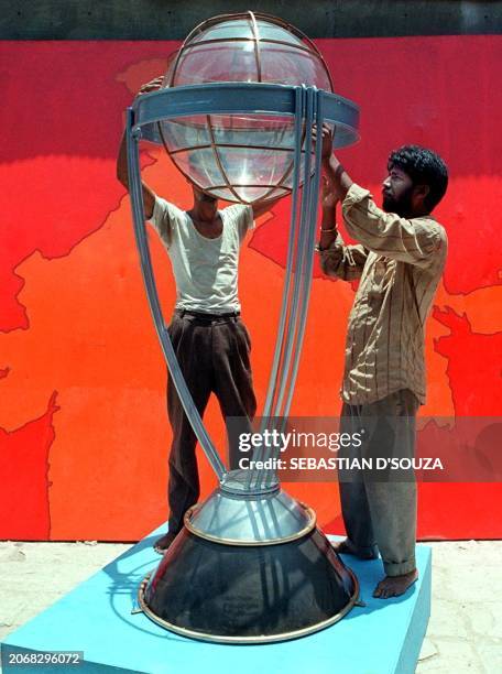 Craftsmen put the final touches to the replica of the World Cup'99 at Samaratha studio in central Bombay 10 May 1999. The cup will tour all the major...