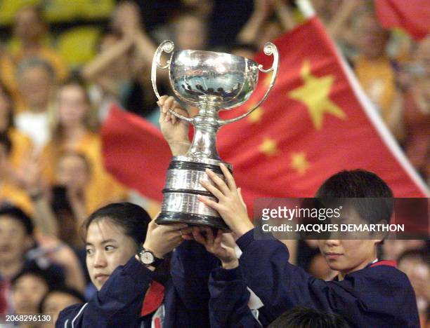 Wang Nan and Li Ju of China hold the trophy after the final of the women's doubles competition of the 45th Table Tennis World Championships in...