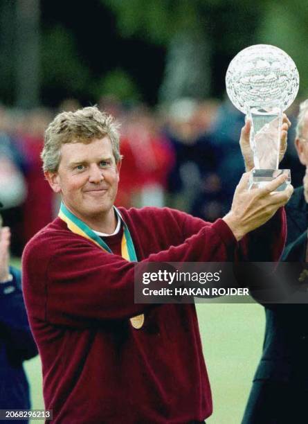 Scotland's Colin Montgomerie raises the trophy after winning the Scandinavian Masters golf tournament in Malmo,08 August 1999. Montgomerie won the...