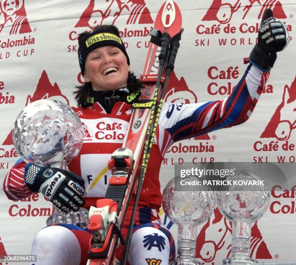Austrian Alexandra Meissnitzer poses on the podium with thre cristal globes, the overall winner's World Cup globe, the super-G and the giant slalom...