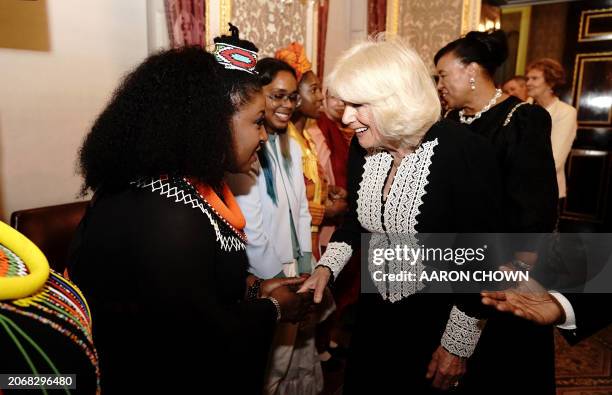 Britain's Queen Camilla meets South African dancers and musicians at a Commonwealth Day Reception at Marlborough House in London, on March 11, 2024 .