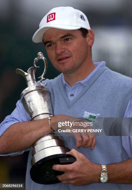 Paul Lawrie of Scotland hugs the cup 18 July 99, after winning the 128th British Open Championship. Lawrie beat Van De Velde of France and Justin...