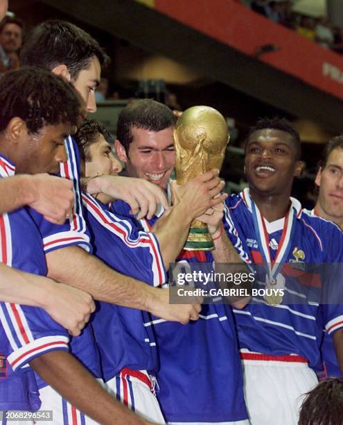 French players Bernard Diomede, Robert Pires, Bixente Lizarazu, Zinedine Zidane, Marcel Desailly and Laurent Blanc celebrate with the 1998 FIFA...