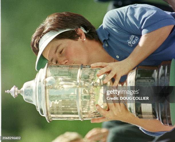 Alison Nicholas of England kisses her trophy after shooting a 10-under-par to win the 1997 US Women's Open Championship at Pumpkin Ridge Golf Club in...