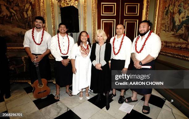 Britain's Queen Camilla poses for a photo with members of a Samoan band at a Commonwealth Day Reception at Marlborough House in London, on March 11,...