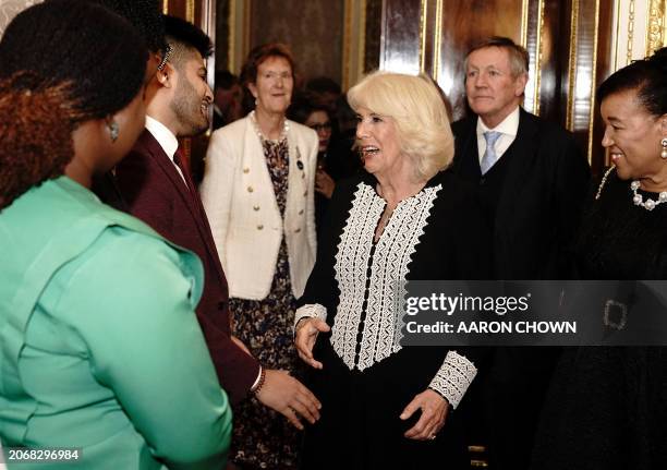 Britain's Queen Camilla talks to guests at a Commonwealth Day Reception at Marlborough House in London, on March 11, 2024 .