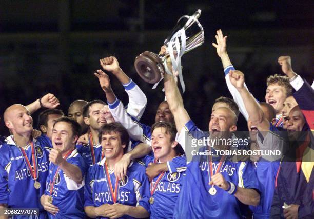 Chelsea's playercoach Gianluca Vialli lifts the cup with cheering teammates after Gianfranco Zola scored the winning goal during their Cup Winner's...