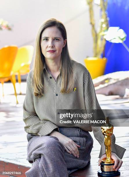 French director and screenwriter Justine Triet poses with her Oscar for Best Original Screenplay for "Anatomy of a Fall" as she attends the brunch...