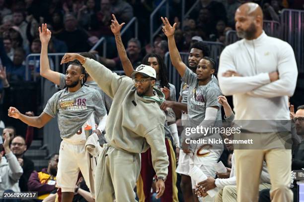 Donovan Mitchell of the Cleveland Cavaliers celebrates with the bench after a three-point basket during the first half against the Phoenix Suns at...