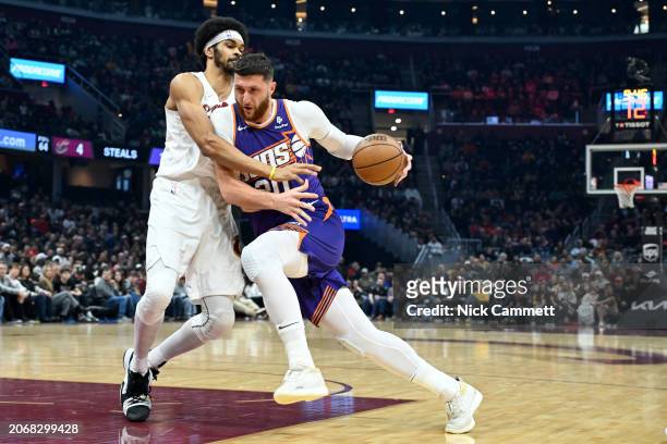 Jusuf Nurkic of the Phoenix Suns drives to the basket against Jarrett Allen of the Cleveland Cavaliers during the first half at Rocket Mortgage...