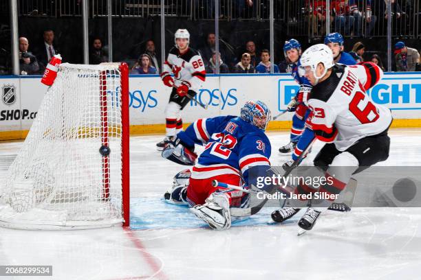 Jonathan Quick of the New York Rangers makes a save against Jesper Bratt of the New Jersey Devils at Madison Square Garden on March 11, 2024 in New...