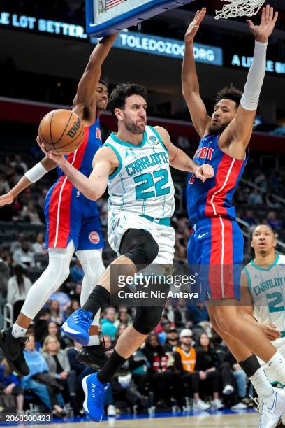 Vasilije Micic of the Charlotte Hornets passes the ball against Jaden Ivey and Cade Cunningham of the Detroit Pistons during the fourth quarter at...
