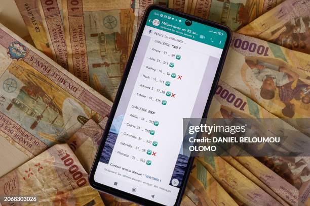 This photograph taken in Yaounde, on February 17, shows an example of a Whatsapp group dedicated to discussions of tontines. In many African...