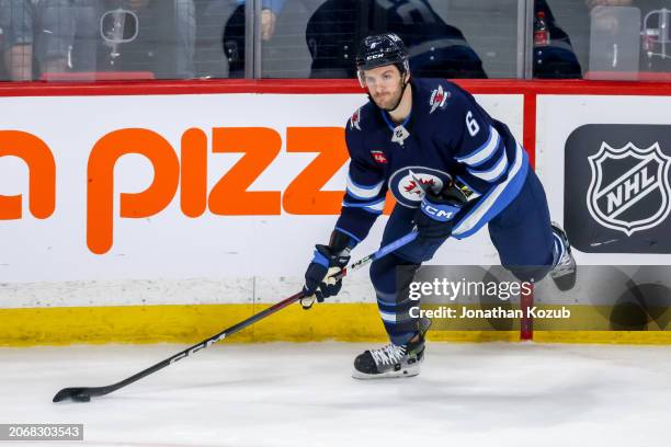 Colin Miller of the Winnipeg Jets plays the puck along the boards during third period action against the Washington Capitals at the Canada Life...