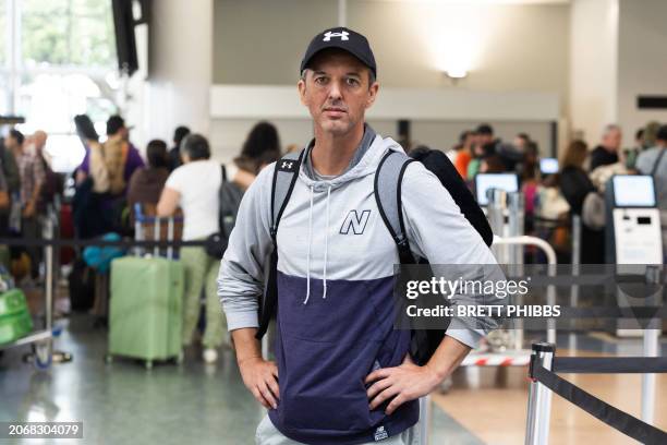 Passenger Gabriel Felipe De Oliveira Adaime stands in front of a line of people at the LATAM Airlines check-in counters at Auckland International...