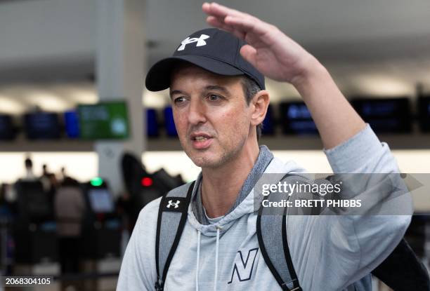 Passenger Gabriel Felipe De Oliveira Adaime gestures as he stands in front of a line of people at the LATAM Airlines check-in counters at Auckland...