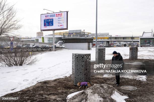 This picture taken on March 6, 2024 shows an electronic billboard displaying an image informing of the online voting in the upcoming Russian...