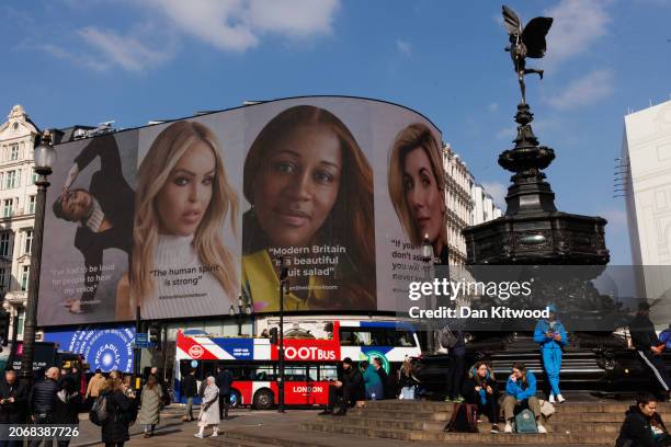 Women role models appear on the screens at Piccadilly Circus on March 8, 2024 in London, England. Nine role models celebrate diverse thought and...