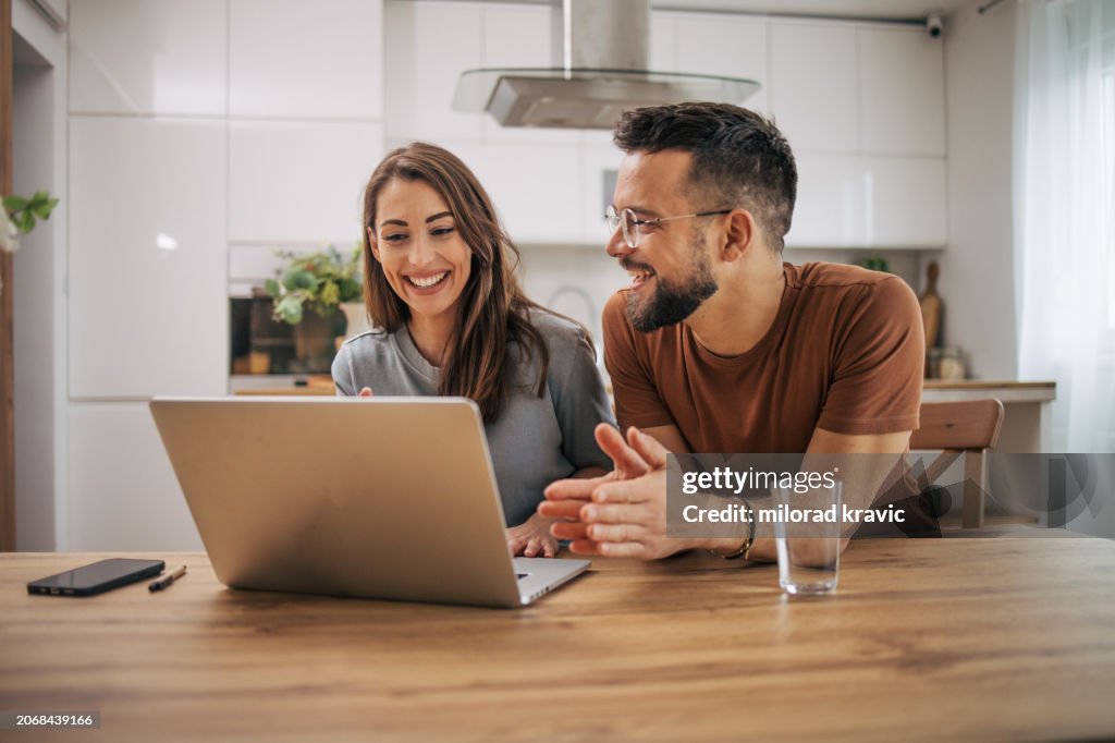 Couple Using One Computer Adult Couple Using Laptop Computer At Home High-Res Stock Photo - Getty ...