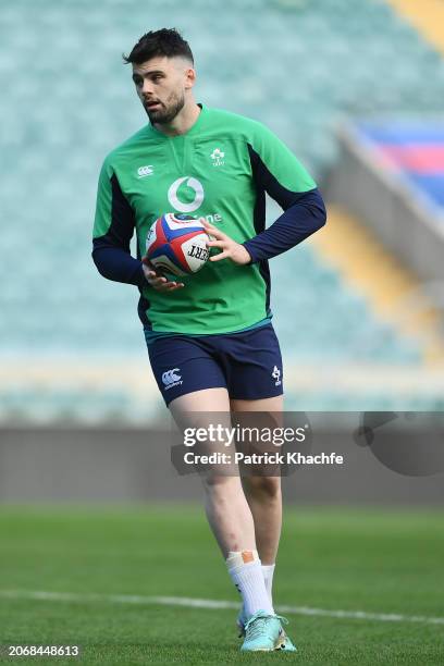 Harry Byrne of Ireland runs with the ball during the Ireland Captain's Run at Twickenham Stadium on March 08, 2024 in London, England.