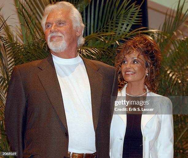 Kenny Rogers and his wife Wanda Miller watch the festivities during the retro premiere of the movie "9 to 5" for the 8th Annual Georgia Campaign for...